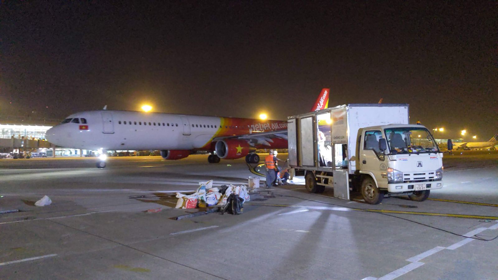 Night-time airport operations beside rapid taxiway concrete repair works by Uretek Asia