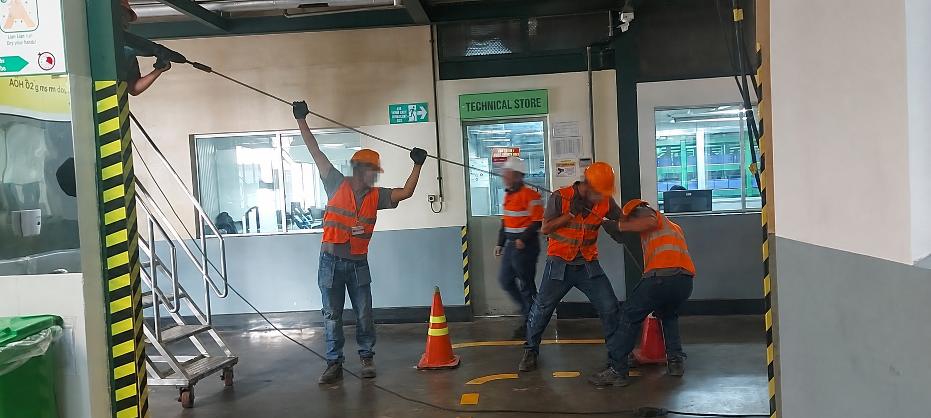 Site team handling a long steel injection pipe